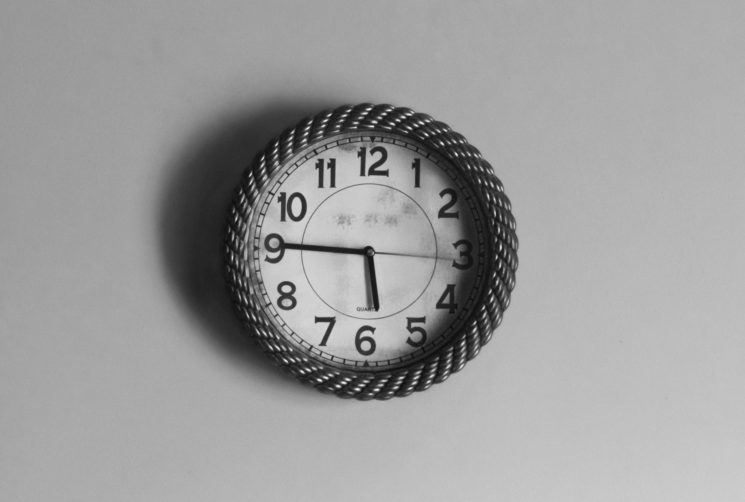 Photograph of a black and white analog clock on a wall