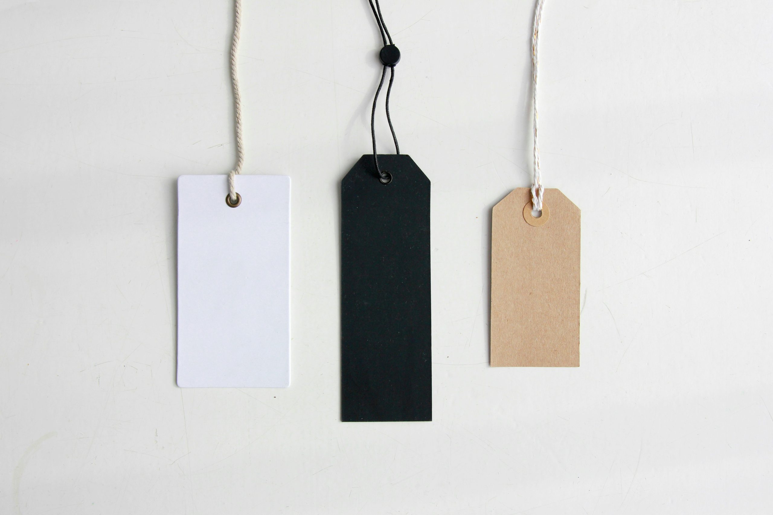 Photograph of three blank gift card tags in slightly different shapes and colors