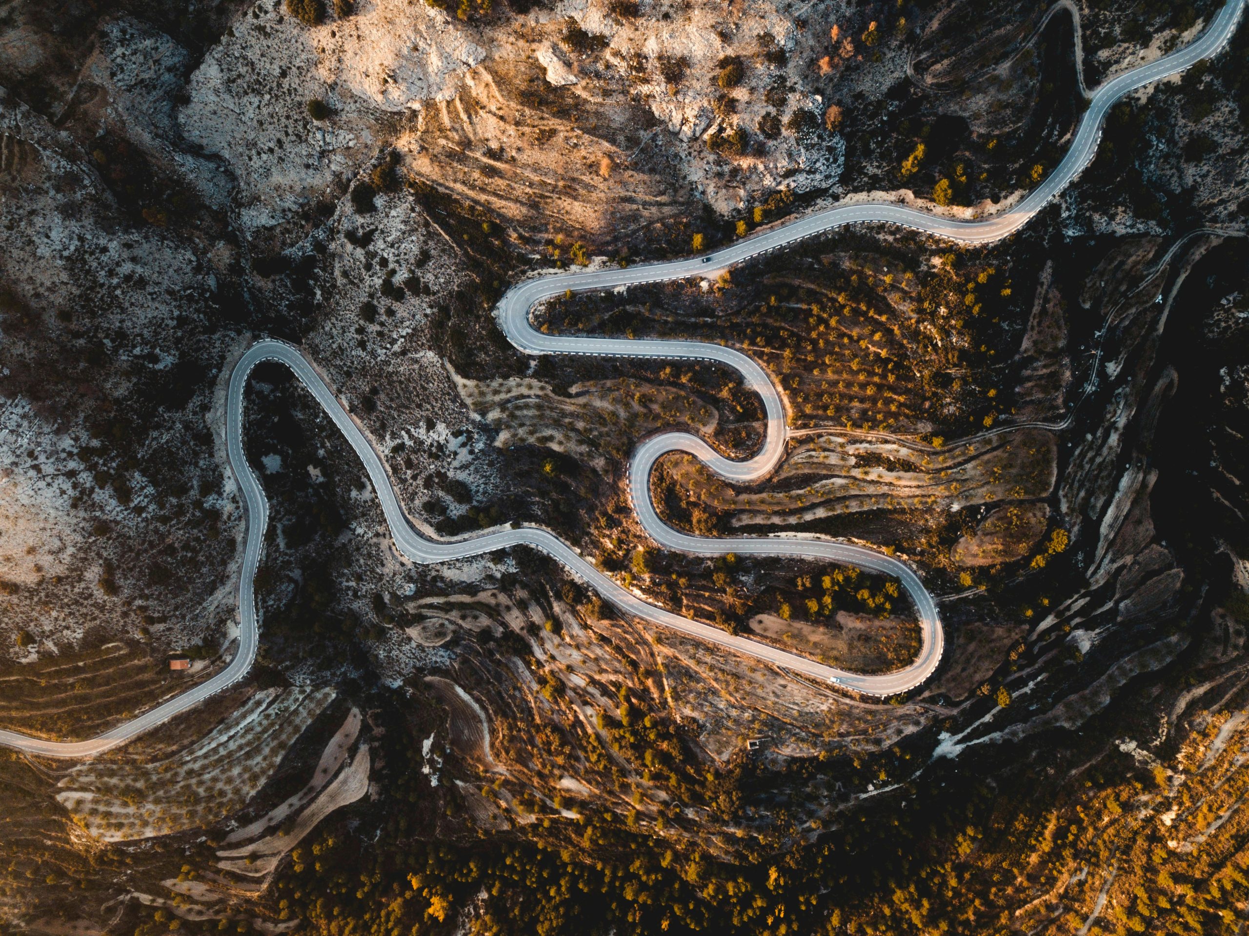 Aerial photograph of a road going through rocky terrain