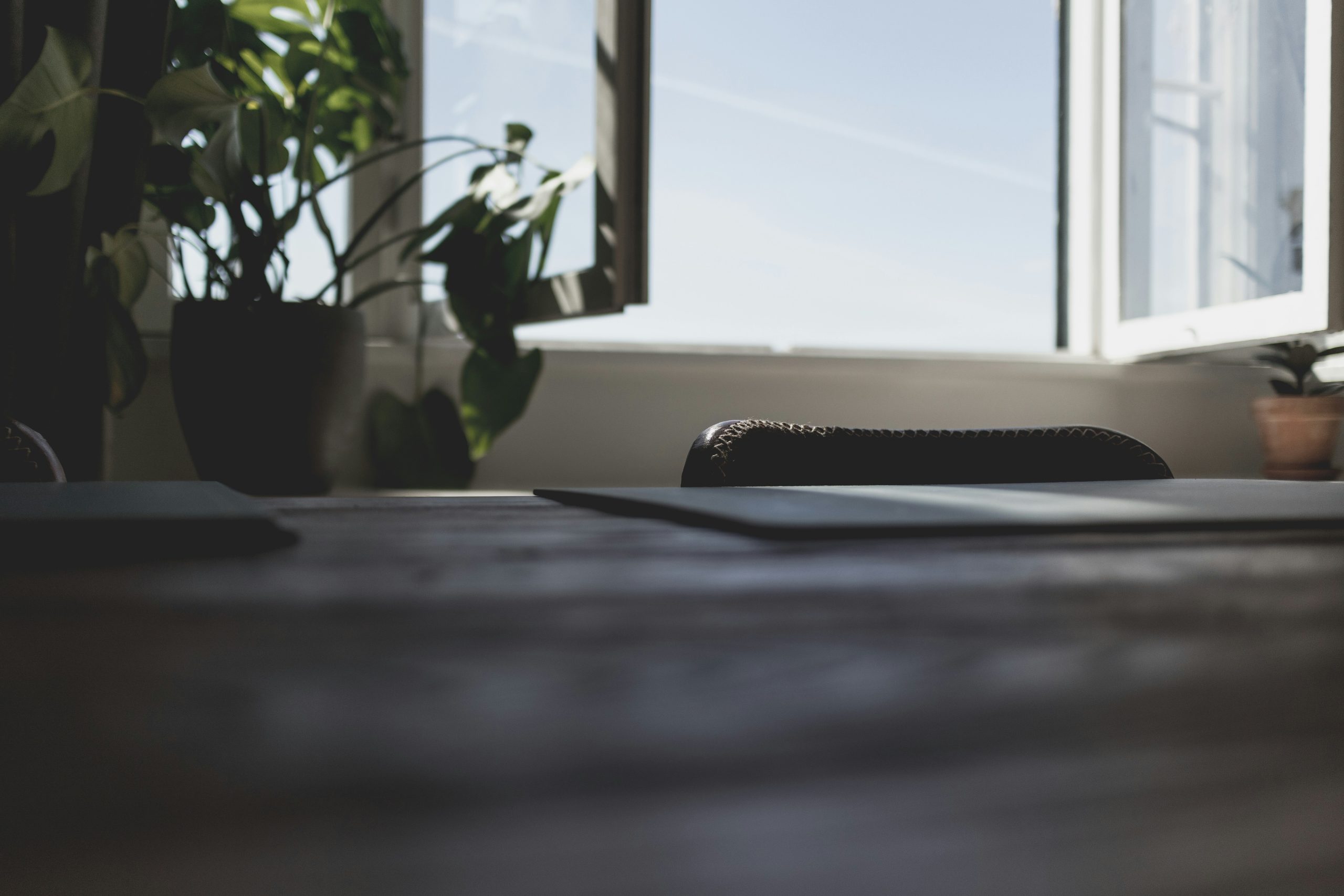 Photograph of a desk with an open window in the background